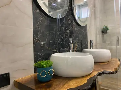 a bathroom with a white sink on a wooden counter at La Luna - High-end 2BD Flat in the TOP centre by Flat Mаnager in Sofia