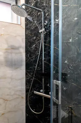 a shower with a shower head in a bathroom at La Luna - High-end 2BD Flat in the TOP centre by Flat Mаnager in Sofia