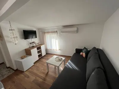 a living room with a couch and a table at The rainbow 5 in Sofia