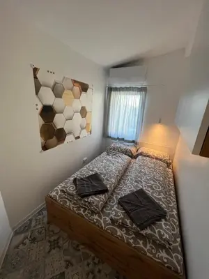 a bedroom with a bed with two pillows on it at The rainbow 6 in Sofia