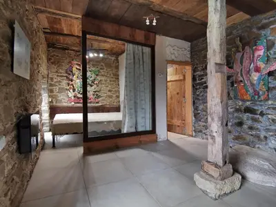 a room with a stone wall with a large mirror at Вила 'Гнездото', Villa 'The nest', Rhodope mountains, Banite in Vishnevo