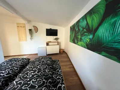 a bedroom with a bed and a painting on the wall at The rainbow 7 in Sofia
