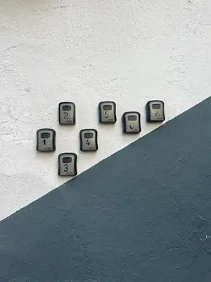 a group of clocks on the side of a wall at The rainbow 7 in Sofia