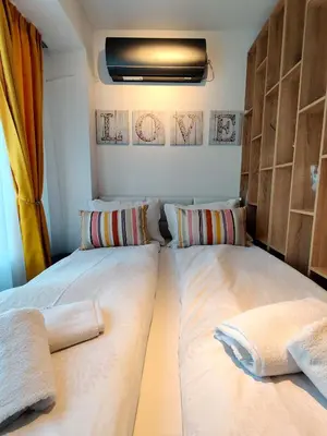 a bedroom with two beds and a window at Cozy Studio near the Historical Heart of Sofia by Flat Mаnager in Sofia