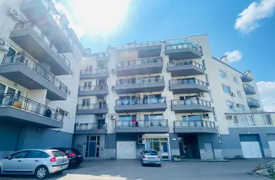 an apartment building with cars parked in front of it at Flower house 2 in Sofia