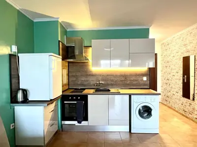 a kitchen with a washing machine and a washer at Flower house 2 in Sofia