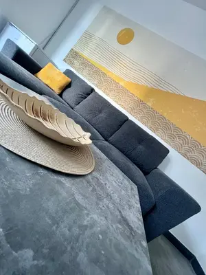 a living room with blue carpet and a table at The rainbow 3 in Sofia