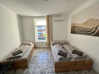 a room with two beds and a window at The rainbow 3 in Sofia