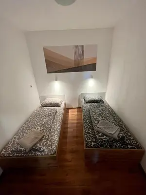 two beds in a room with a ceiling at The rainbow 3 in Sofia