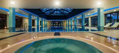 a large swimming pool in a building with a pool at Saint George Palace Deluxe Collection in Bansko