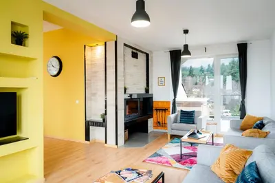 a living room with a couch and a fireplace at Saint George Palace Deluxe Collection in Bansko