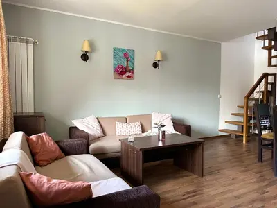 a living room with a couch and a table at Penthouse at Dream Bansko in Bansko