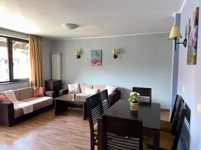 a living room with a couch and a table at Penthouse at Dream Bansko in Bansko