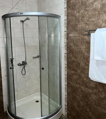 a shower with a glass door in a bathroom at Penthouse at Dream Bansko in Bansko