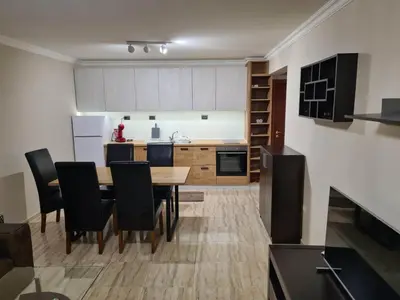 a kitchen and dining room with a table and chairs at Апартамен в Манастира 3 in Smolyan