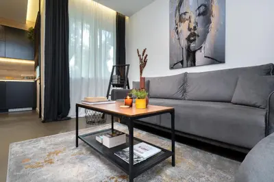 a living room with a couch and a coffee table at Lozenets Modern Apartment Tranquil & Central in Sofia