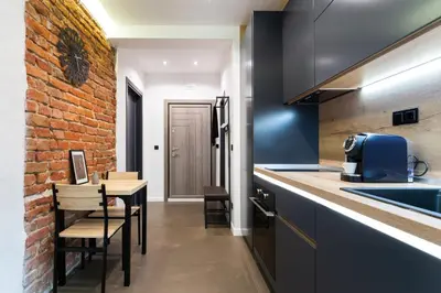 a kitchen with a counter and a brick wall at Lozenets Modern Apartment Tranquil & Central in Sofia