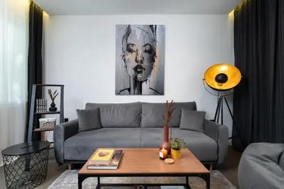 a living room with a couch and a table at Lozenets Modern Apartment Tranquil & Central in Sofia