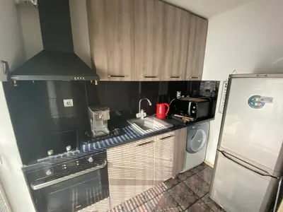 a kitchen with a sink and a stove and a refrigerator at Central Studio with Lovely Terrace & Free street Parking in Plovdiv