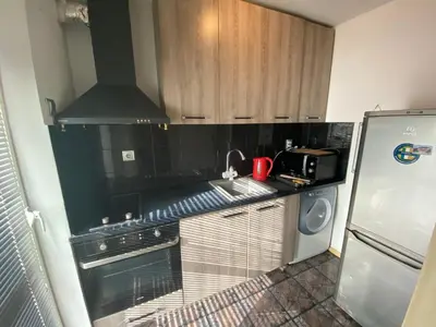 a kitchen with a stove top oven next to a refrigerator at Central Studio with Lovely Terrace & Free street Parking in Plovdiv