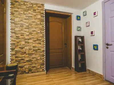 a room with a brick wall next to a door at Top Center Studio 1 in Sofia