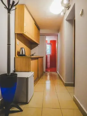 a room with a kitchen with a red door at Top Center Apartment 2 in Sofia