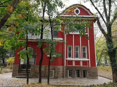a red and white building with trees in front of it at Top Center Studio 3 in Sofia