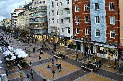 a group of people walking in a city with buildings at Top Center Apartment 4 in Sofia