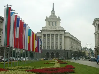 a row of flags in front of a building at Top Center Apartment 4 in Sofia