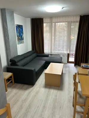 a living room with a couch and a table at Комплекс Замъка 2 ап 301 in Pamporovo