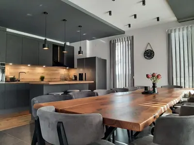 a dining room with a large wooden table and chairs at Вила Bora Vista 1 in Tsigov Chark