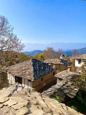 an old stone building on top of a mountain at Къща за гости Близнаците in Leshten