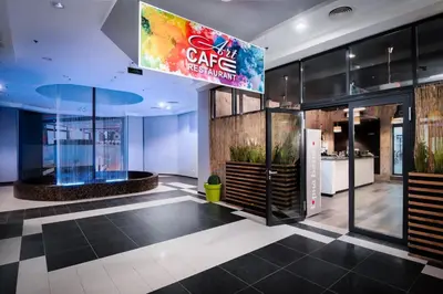 a lobby of a building with a sign for a cafe at Art Magus Hotel in Sofia