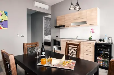 a kitchen with a dining room table with a counter top at Art Magus Hotel in Sofia