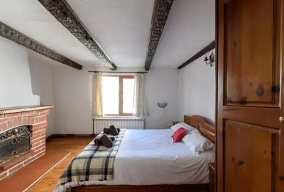 a bedroom with a bed in a room with a fireplace at Chalet Mila - Total Chalets - Fully Catered in Bansko