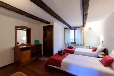 a hotel room with two beds and a mirror at Chalet Mila - Total Chalets - Fully Catered in Bansko