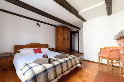 a bedroom with a bed with two teddy bears on it at Chalet Mila - Total Chalets - Fully Catered in Bansko