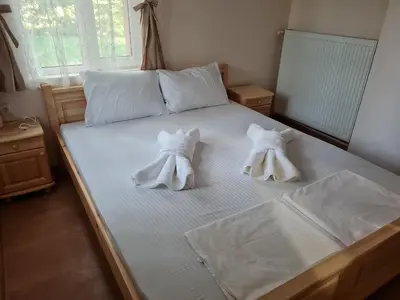 a bed with two towel animals on it at Вила Вайлин in Batak