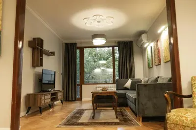 a living room with a couch and a table at Jasmine Central Apartment in Sofia