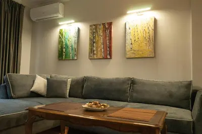 a living room with a couch and a table at Jasmine Central Apartment in Sofia