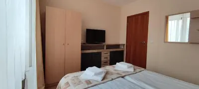 a small bedroom with a bed and a television at Apartment SUNNY&RELAX Pamporovo The Castle 2 in Pamporovo