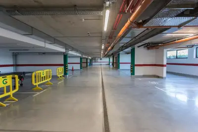 an empty parking garage with yellow benches in it at Complex Gallery Vitosha **** in Sofia
