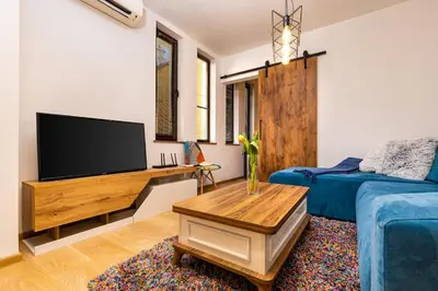 a living room with a flat screen tv and a couch at 'Little Little' House in the town CENTER & PARKING in Plovdiv