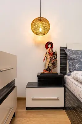 a room with a bed and a table with a statue at 'Little Little' House in the town CENTER & PARKING in Plovdiv