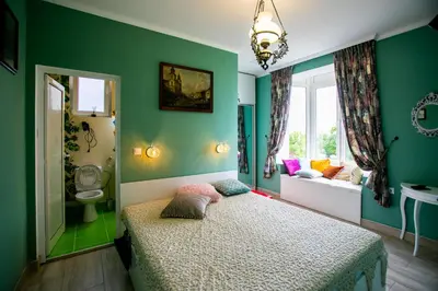 a green bedroom with a bed and a window at Къща за гости Кала in Patalenitsa