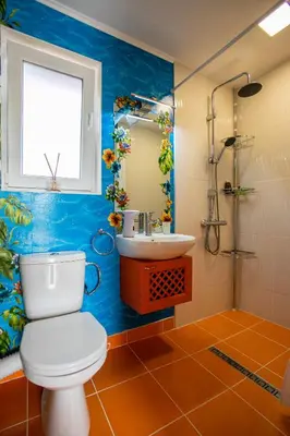 a bathroom with a toilet and a sink at Къща за гости Кала in Patalenitsa