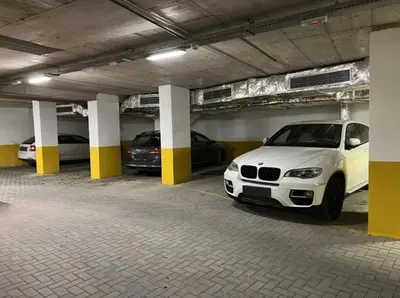 a parking garage with two cars parked in it at Green Eyes Apartments in Sofia