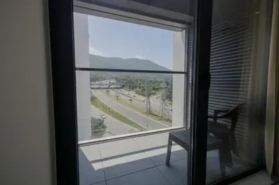 a window with a chair and a view of a street at Green Eyes Apartments in Sofia