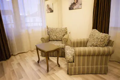 a living room with two chairs and a table at Hotel Leda in Sofia
