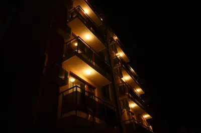 a building with lights on the side of it at night at Hotel Leda in Sofia